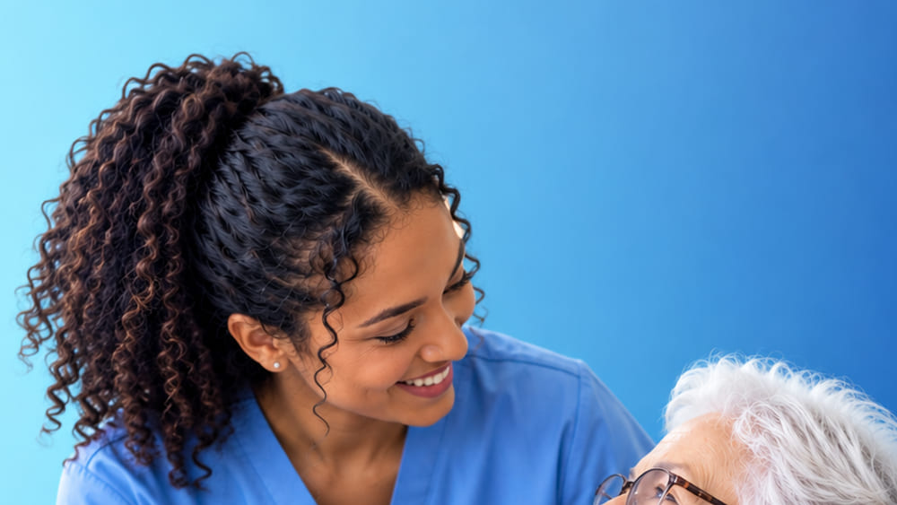 A caregiver talking warmly with an older resident